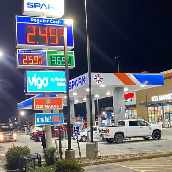 Signage shows the price of unleaded regular gas at less than $2.50 per gallon as cars queue to fill fuel at a gas station, in Houston, Texas, U.S., December 5, 2023. REUTERS/Gary McWilliams